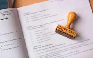 A wooden stamp resting on an open book