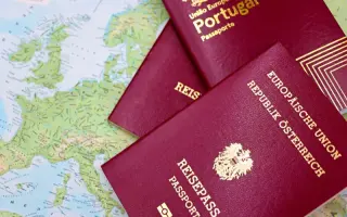 Austrian and Portuguese passports lying on a map